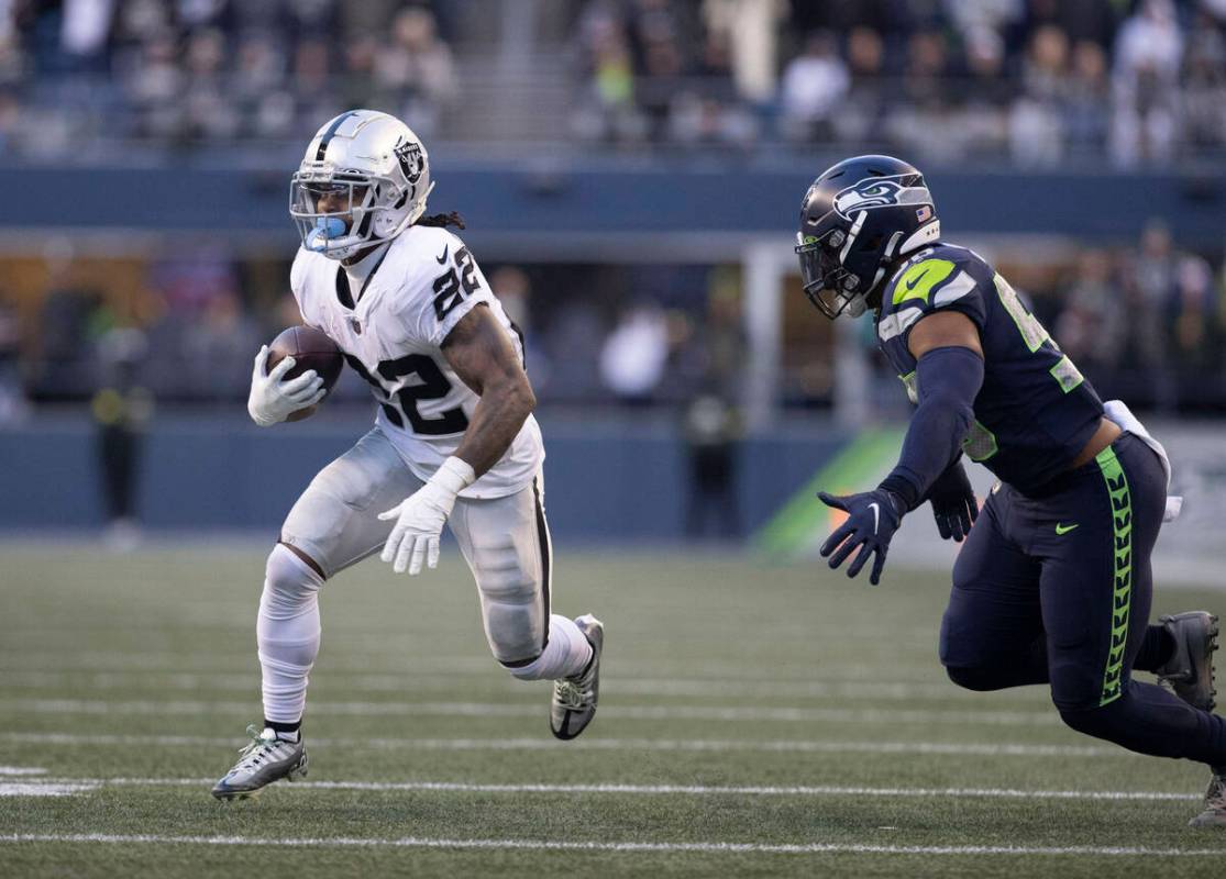 Raiders running back Ameer Abdullah (22) looks for room to run against Seattle Seahawks linebac ...