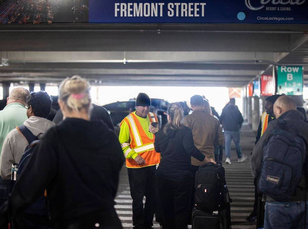 Travelers walk through terminal 1 at Harry Reid International Airport on Sunday, Nov. 27, 2022, ...