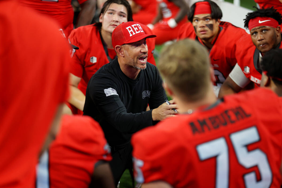 UNLV Rebels head coach Marcus Arroyo speaks to his platers in the second half of a NCAA footbal ...