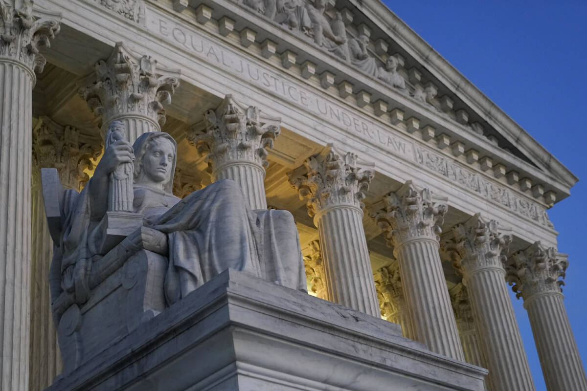 Light illuminates part of the Supreme Court building on Capitol Hill in Washington, Wednesday, ...