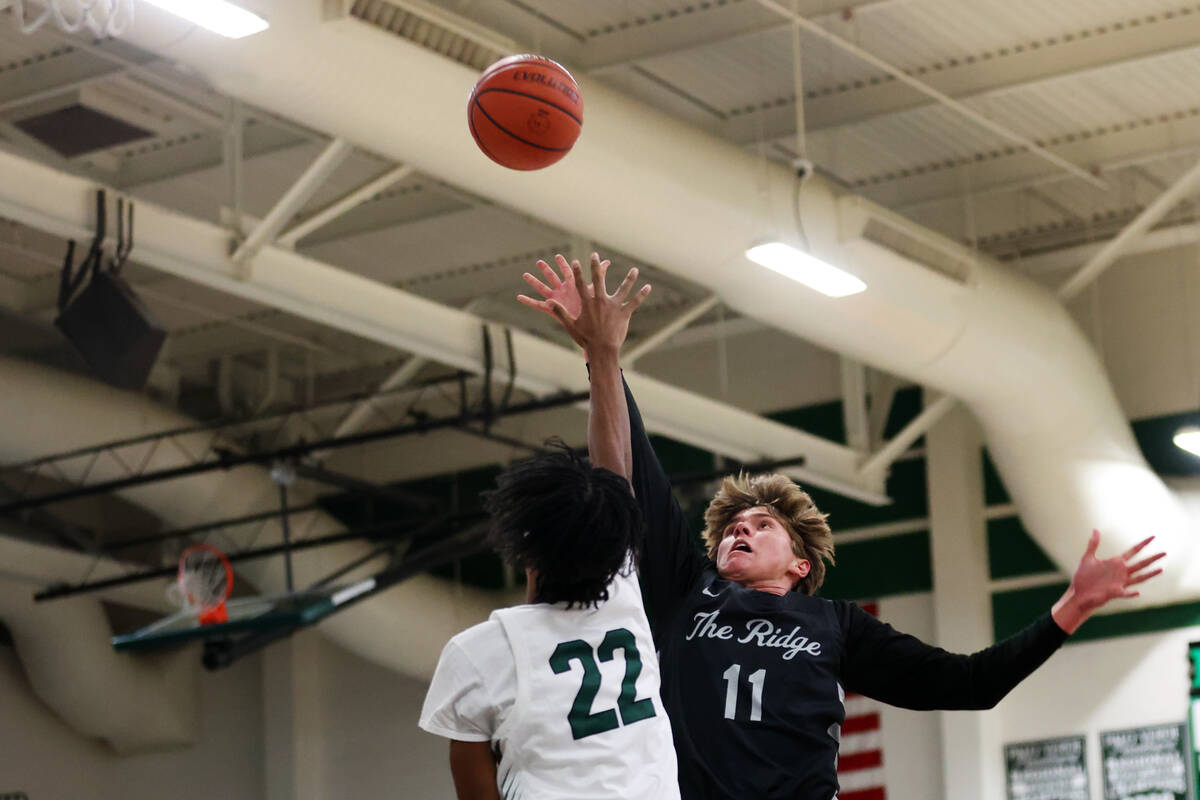 Shadow Ridge's Brock Morrow (11) shoots the ball under pressure from Palo Verde's Takeo Moore ( ...