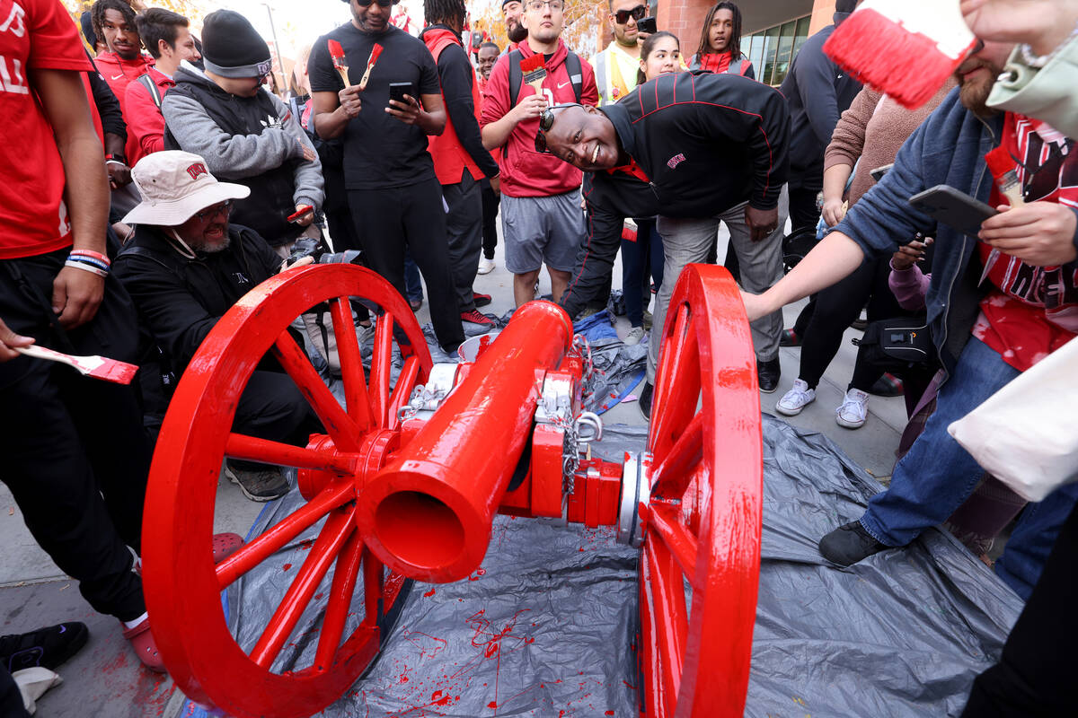 UNLV Football players, students and athletic director Erick Harper, center, paint the Fremont C ...