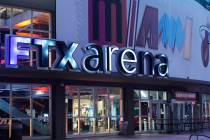 Signage for the FTX Arena, where the Miami Heat basketball team plays, is illuminated Saturday, ...