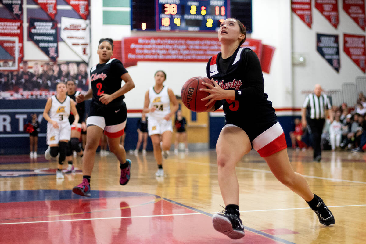 Liberty’s Sydney Chestnut (5) runs to shoot after breaking away with the ball during a h ...