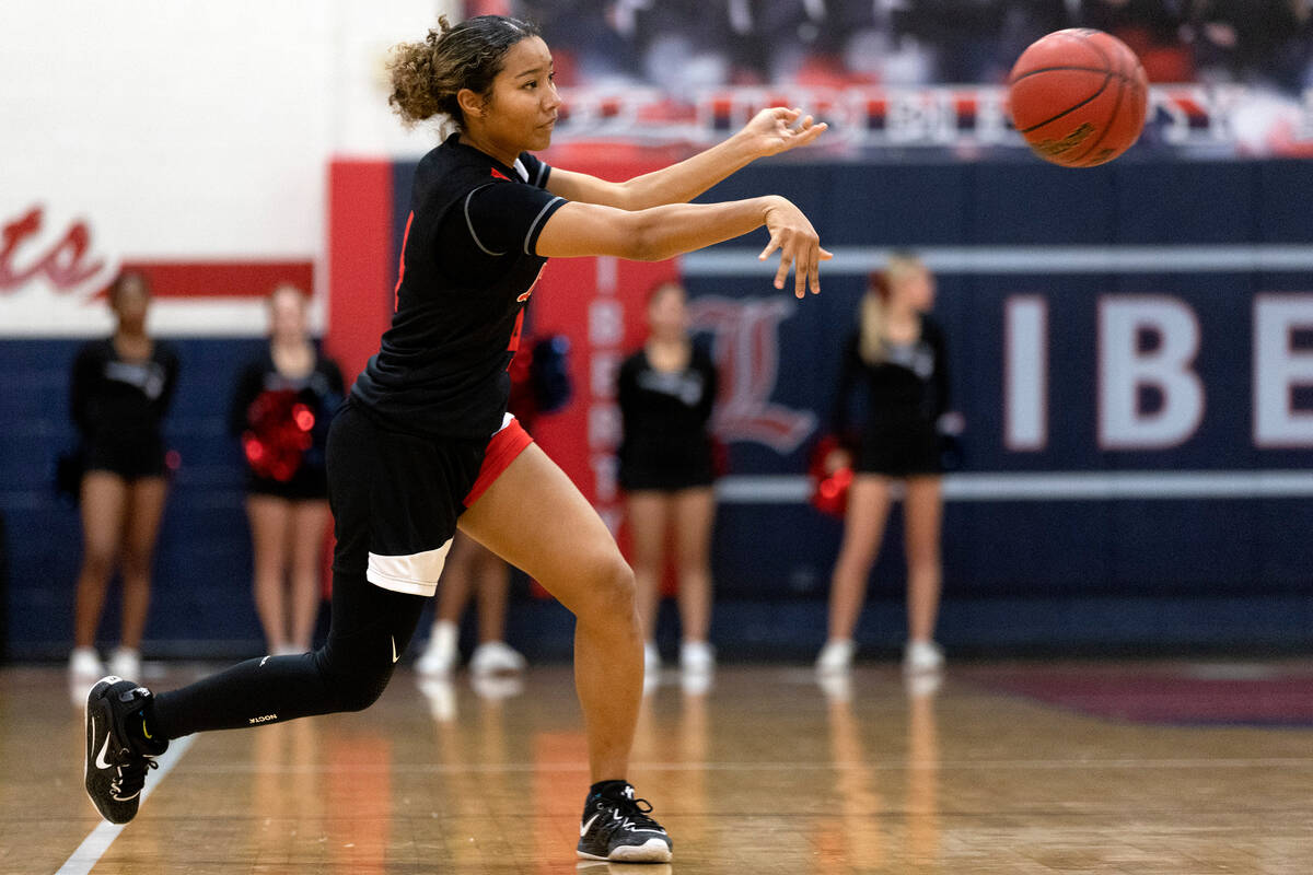 Liberty’s Satsuki Bradley (4) passes the ball during a high school girls basketball game ...