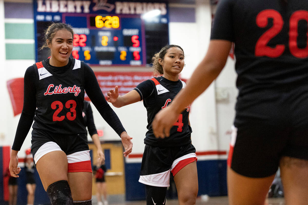 Liberty’s Adrienne Puletasi (23) and Satsuki Bradley, center, congratulate Payton Gates ...