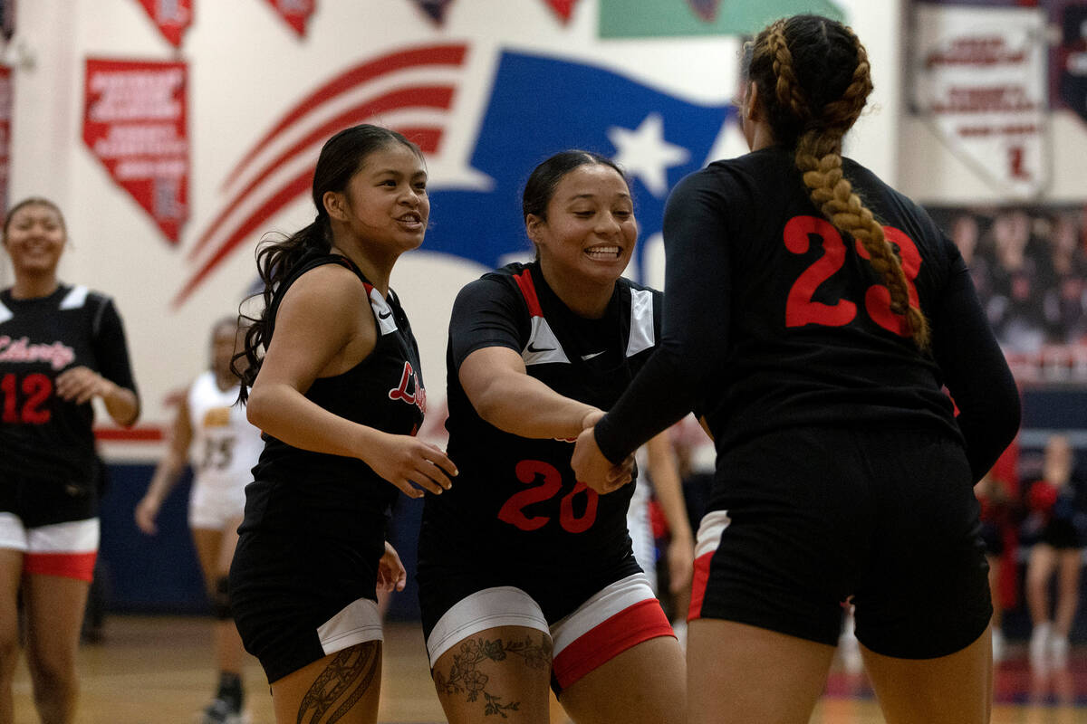 Liberty’s Jossy Calizo, left, and Payton Gates (20) congratulate Adrienne Puletasi (23) ...