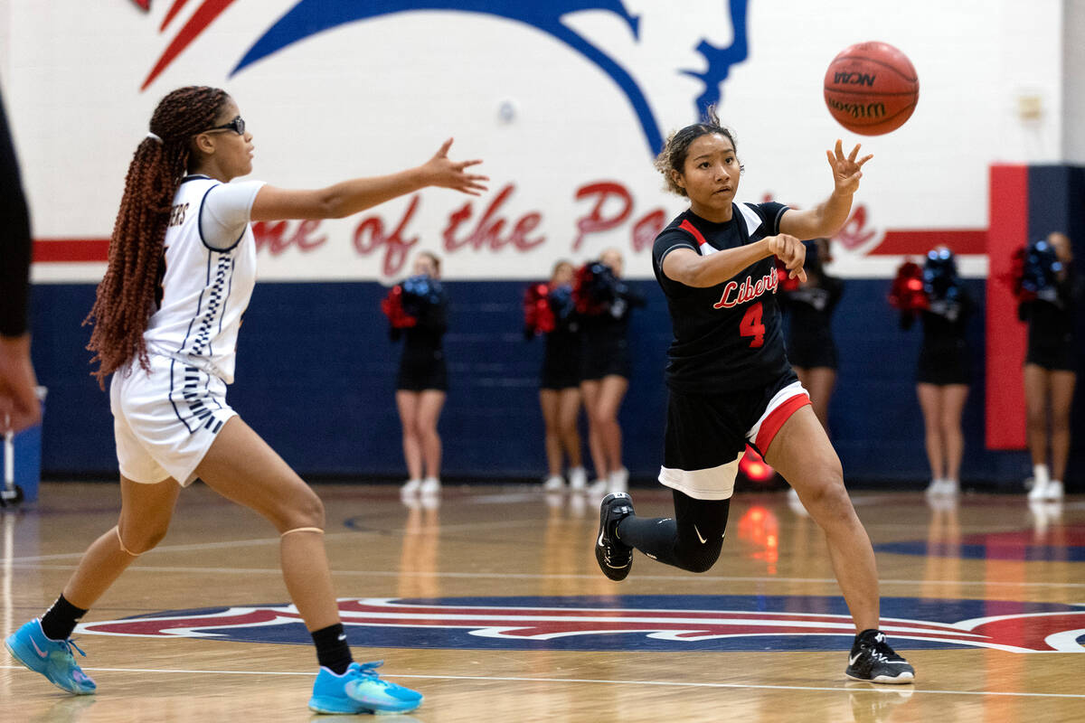 Liberty’s Satsuki Bradley (4) passes up the court while Clark’s Anaya Williams, l ...