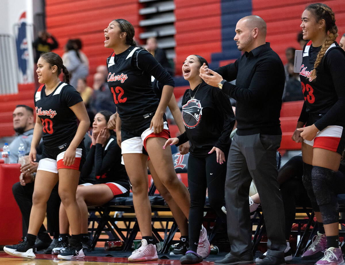 The Liberty bench cheers for their team during a high school girls basketball game against Clar ...