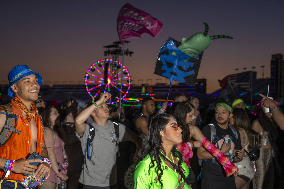 Fans dance to music in between sets during the first day of the Electric Daisy Carnival at Las ...