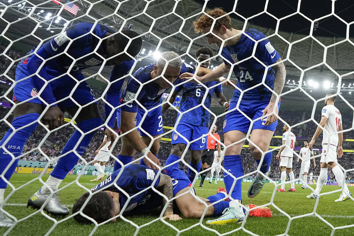 Christian Pulisic of the United States is assisted by teammates after scoring his side's openin ...