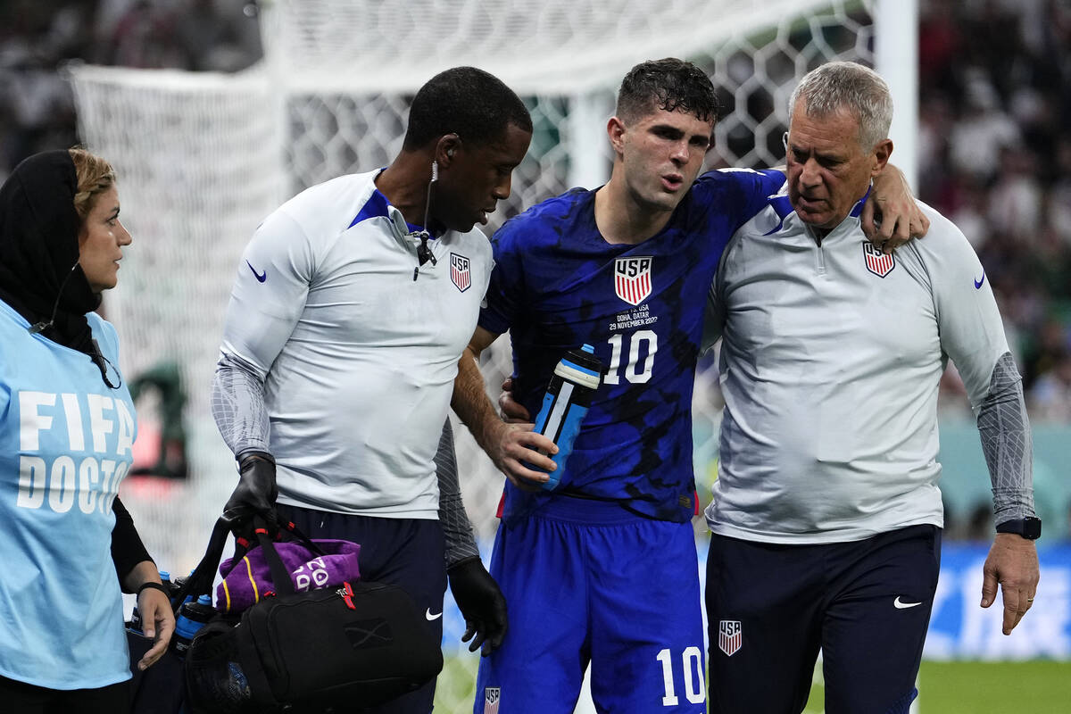 Christian Pulisic of the United States is helped off the pitch after suffering an injury during ...