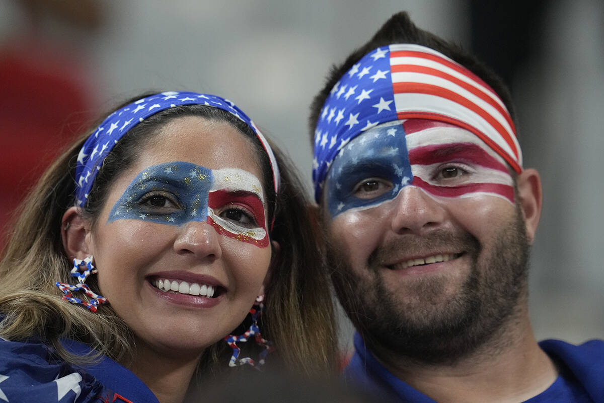 U.S soccer fans with face paint smile before the World Cup group B soccer match between Iran an ...