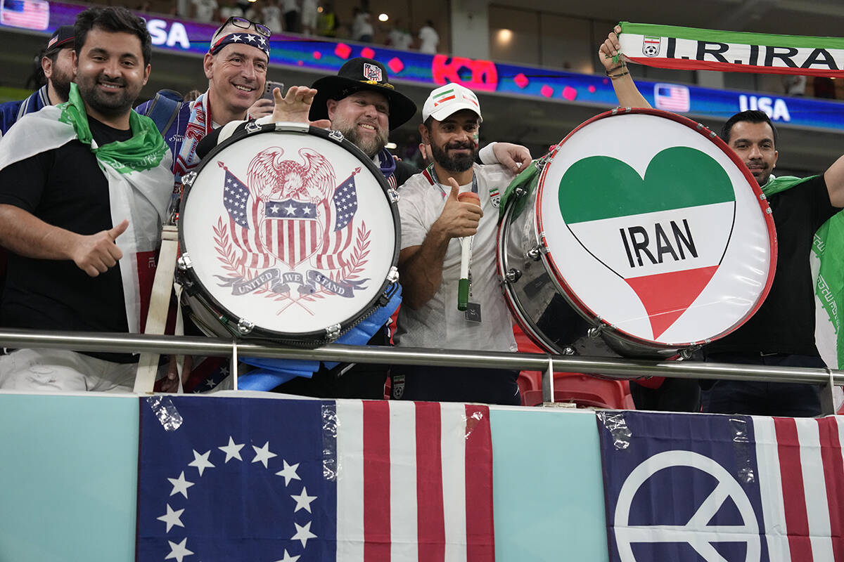 United States and Iranian soccer fans pose before the World Cup group B soccer match between Ir ...