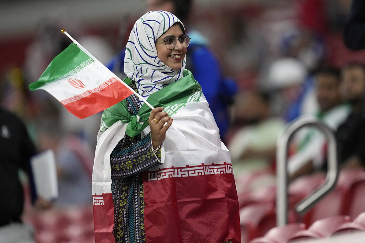 An Iranian woman soccer fan poses before the World Cup group B soccer match between Iran and th ...
