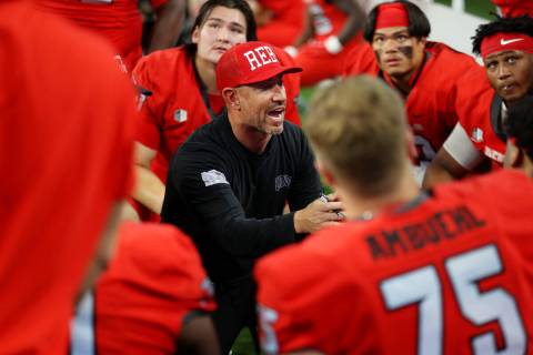 UNLV Rebels head coach Marcus Arroyo speaks to his platers in the second half of a NCAA footbal ...