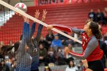 Arbor View’s Willow Watson spikes to Basic’s Martina Moro, left, and Annamarie Ra ...