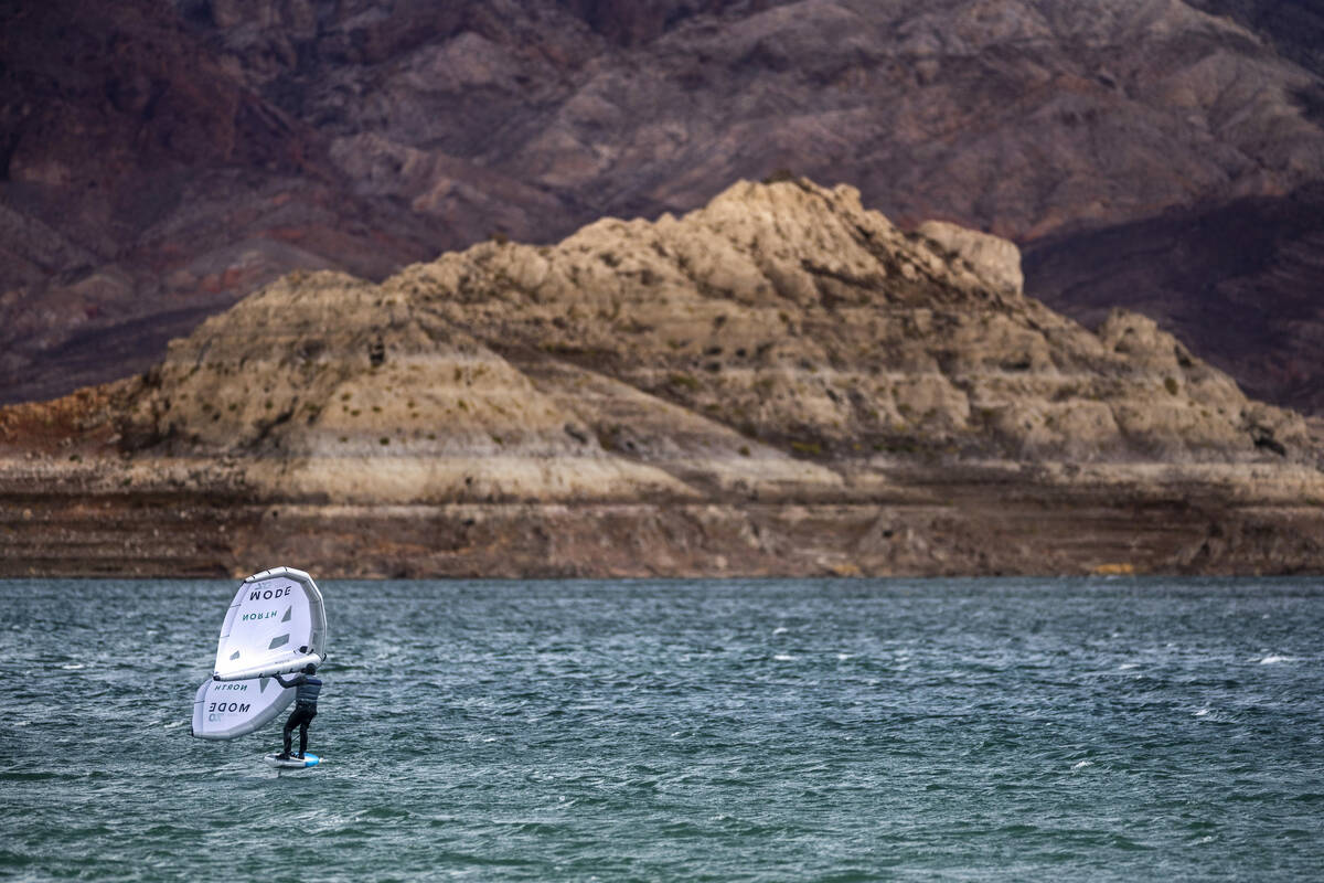 A board sailer takes advantage of strong winds as water levels continue to recede in Lake Mead ...