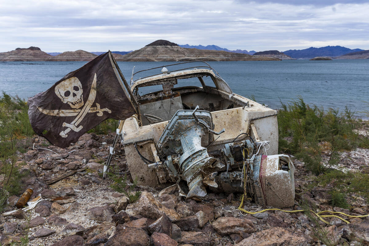 An abandoned boat remains formerly under water along the recently exposed shoreline at the Lake ...