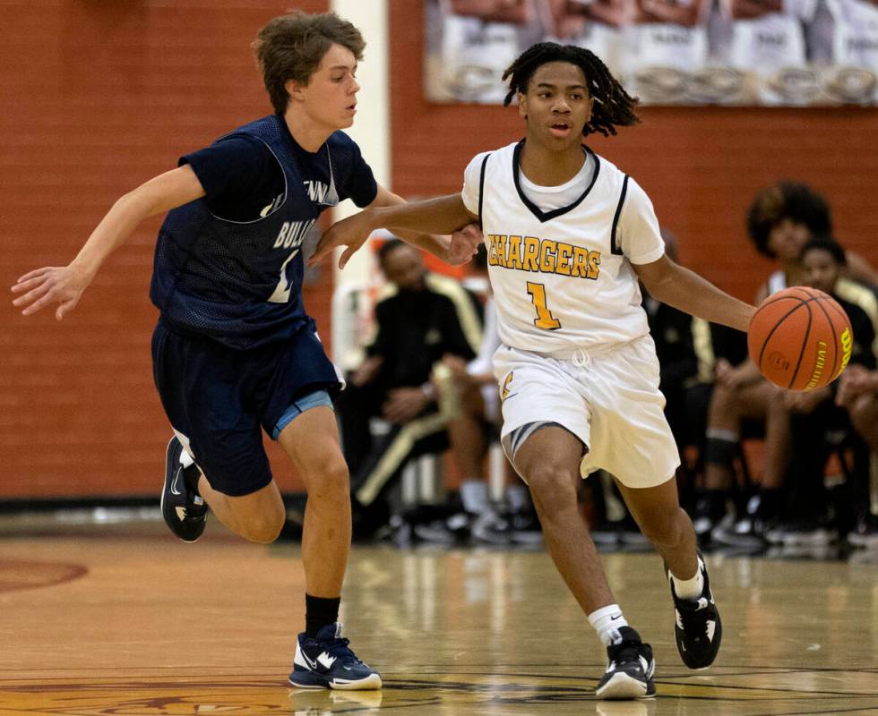 Clark’s Mario Allen (1) dribbles up the court while Centennial’s Gavin Ahlstrom ( ...