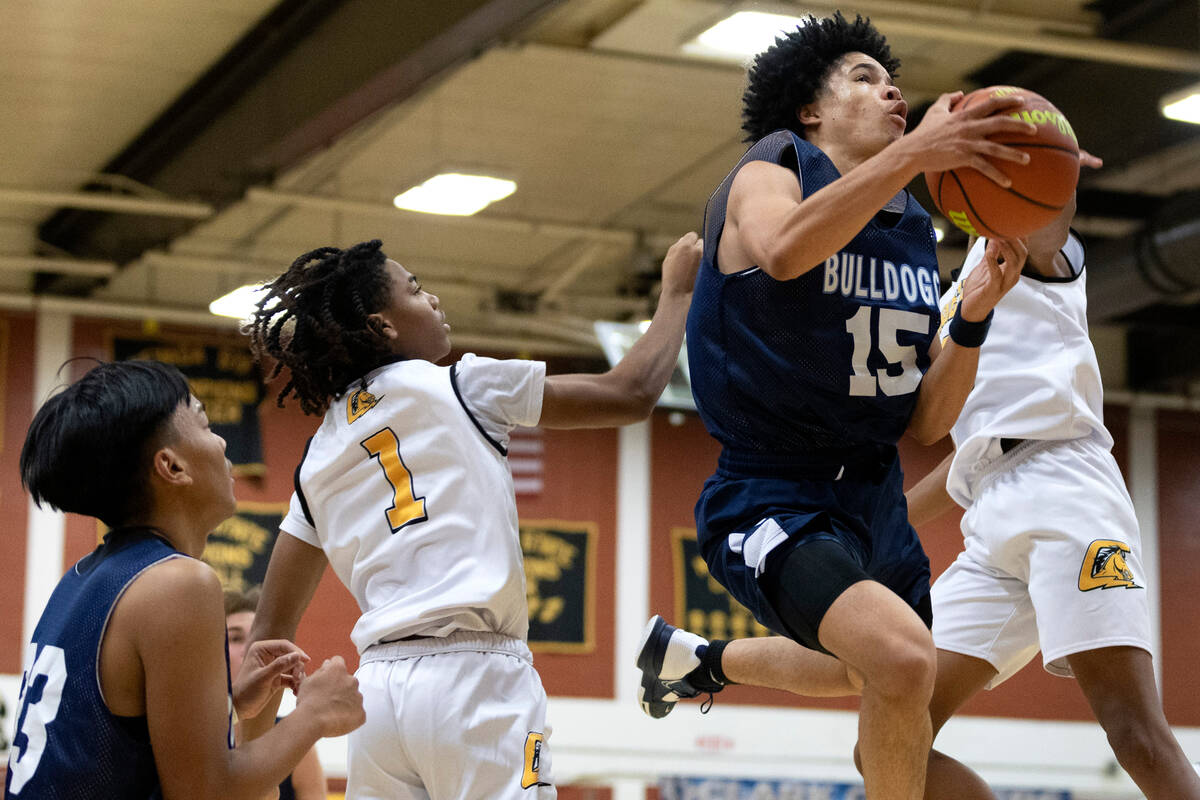 Centennial’s Elijah Burney (15) jumps to shoot against Clark’s Zyon Harris (1) du ...