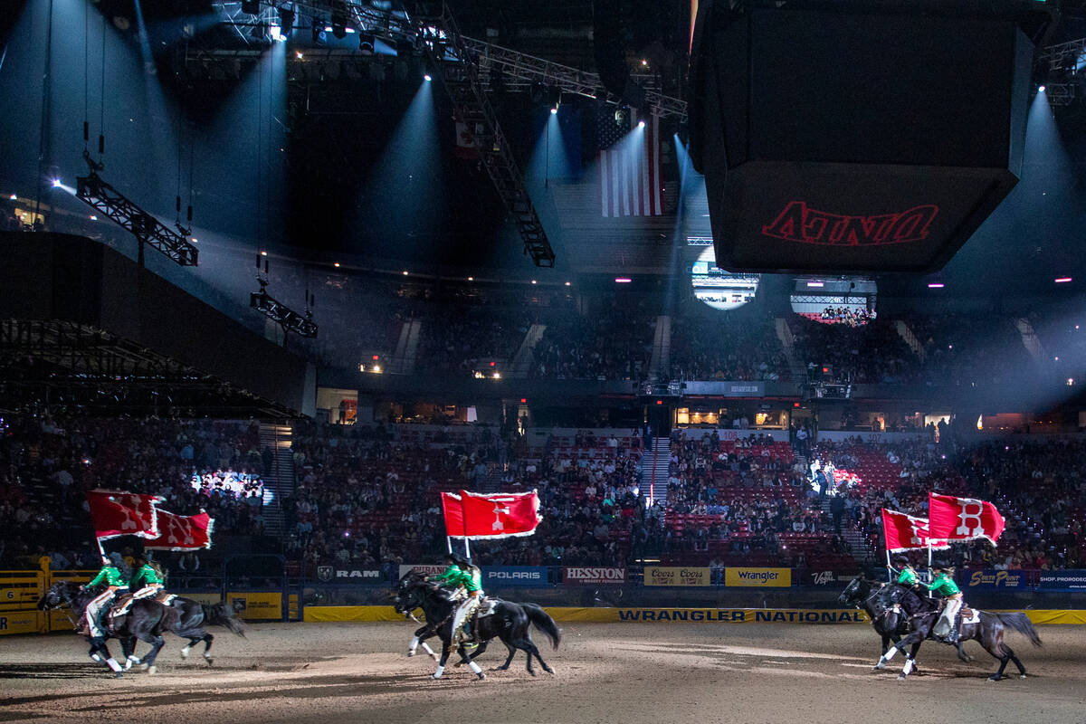 Rodeo flag bearers enter the arena to start Day 2 of the Wrangler National Finals Rodeo at the ...