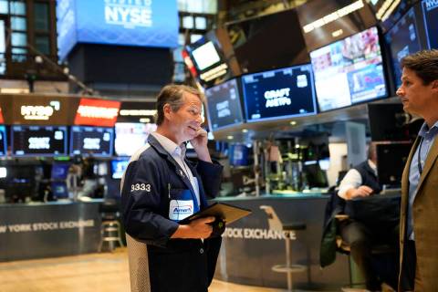 Traders work on the floor at the New York Stock Exchange in New York, Monday, Nov. 28, 2022. (A ...