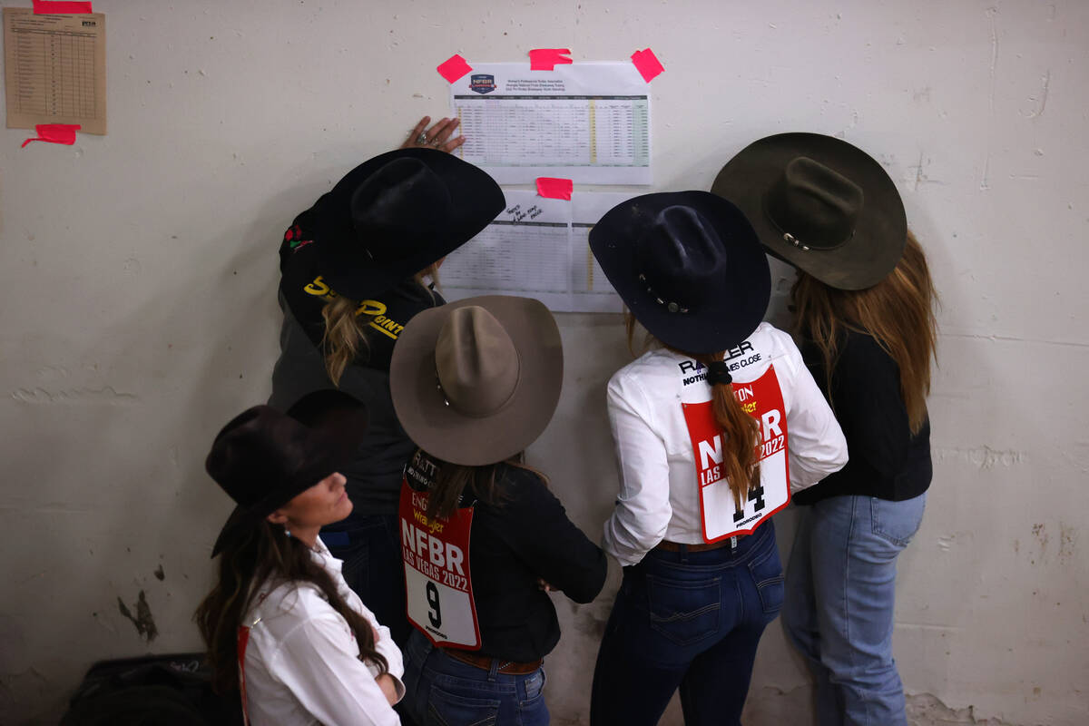 Competitors look at the standings sheet during the women's Wrangler National Finals Breakaway R ...