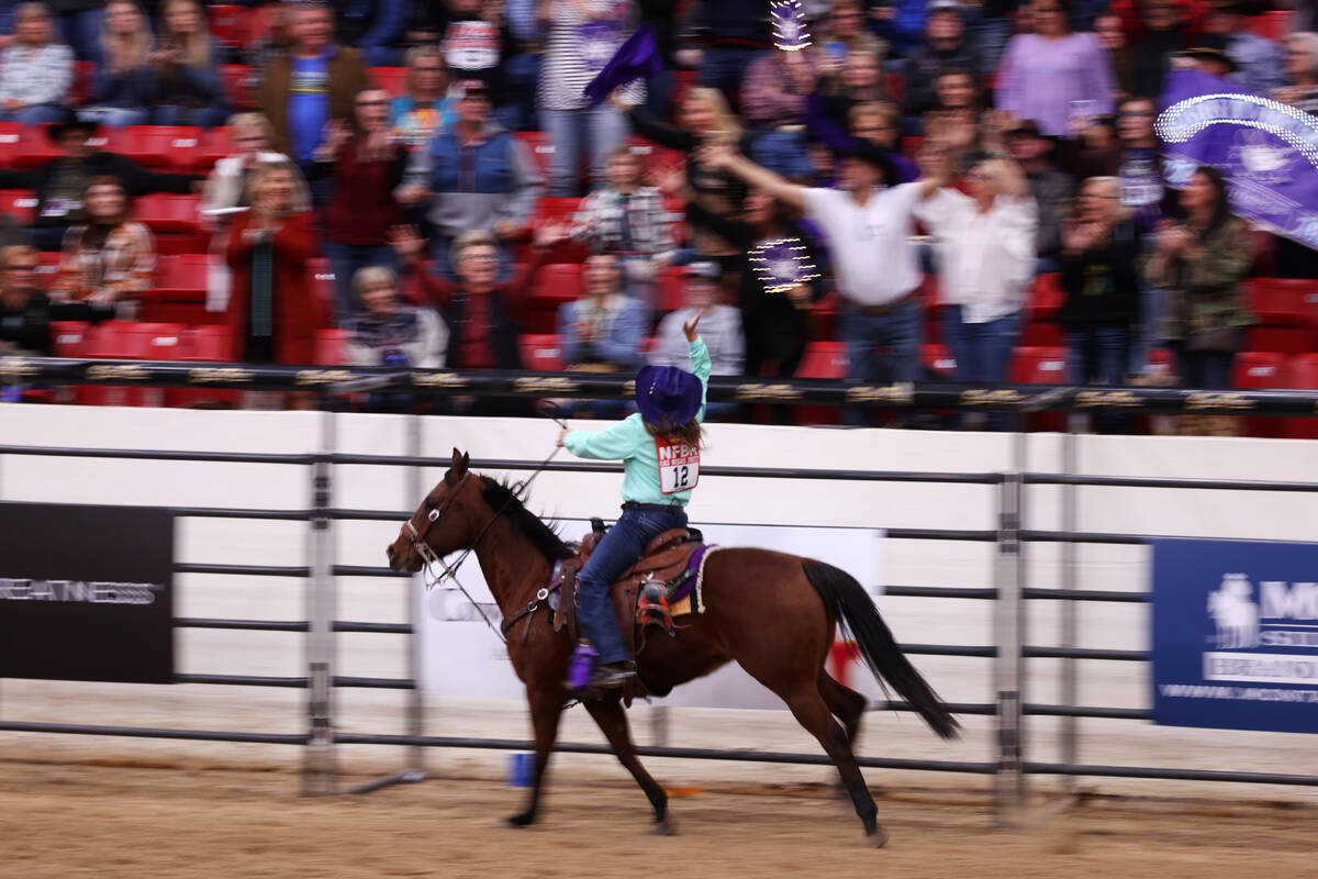 JJ Hampton runs a lap with her horse after winning a round in the women's Wrangler National Fin ...