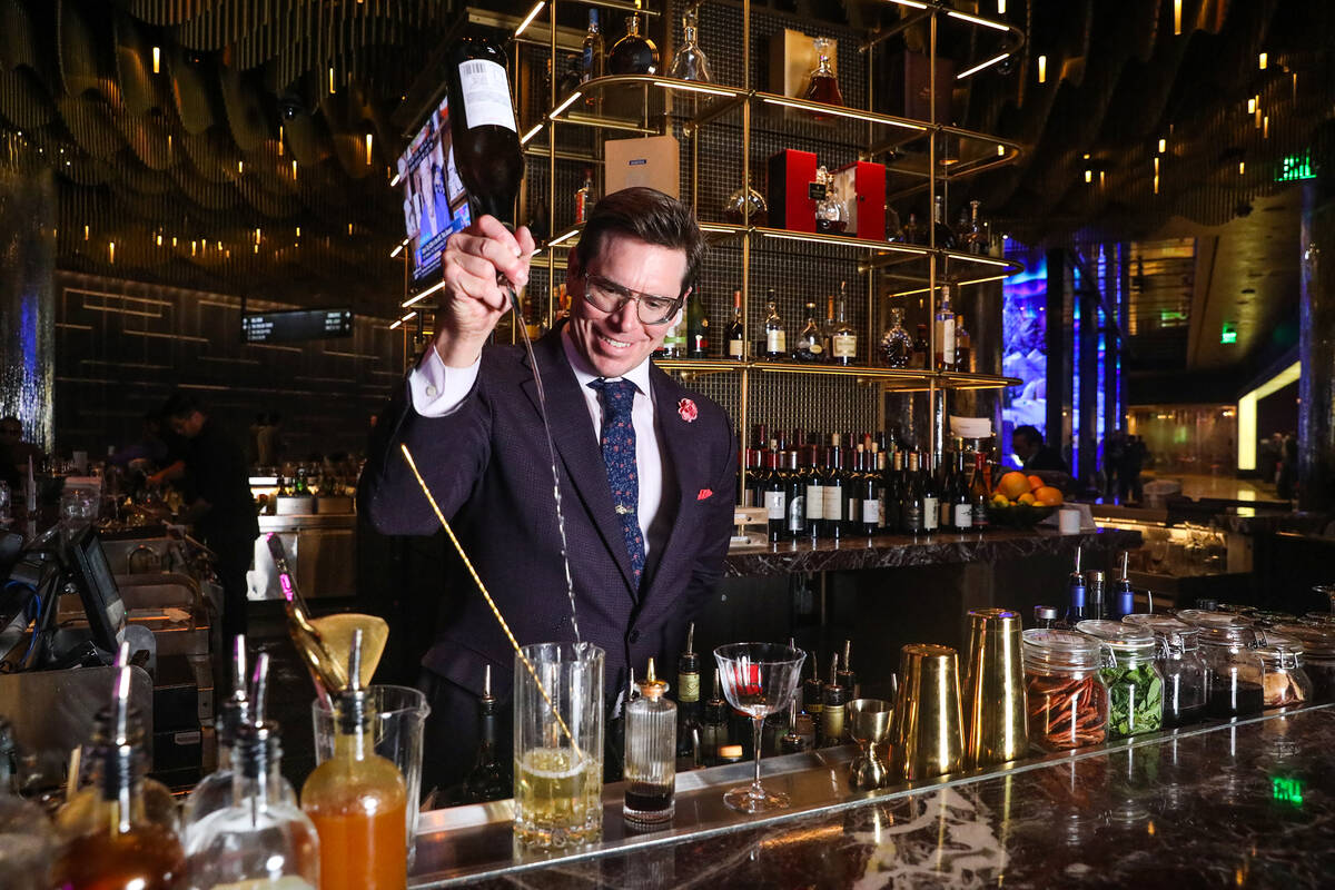Andrew Pollard, property mixologist, makes a drink at the Vesper Bar at The Cosmopolitan of Las ...