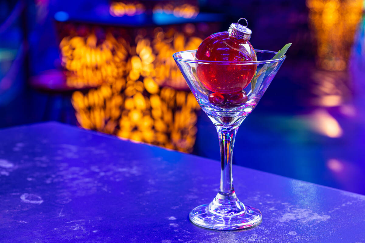 A Jungle Ball cocktail from Oddwood Bar in Area 15 in Las Vegas is poured from a Christmas orna ...