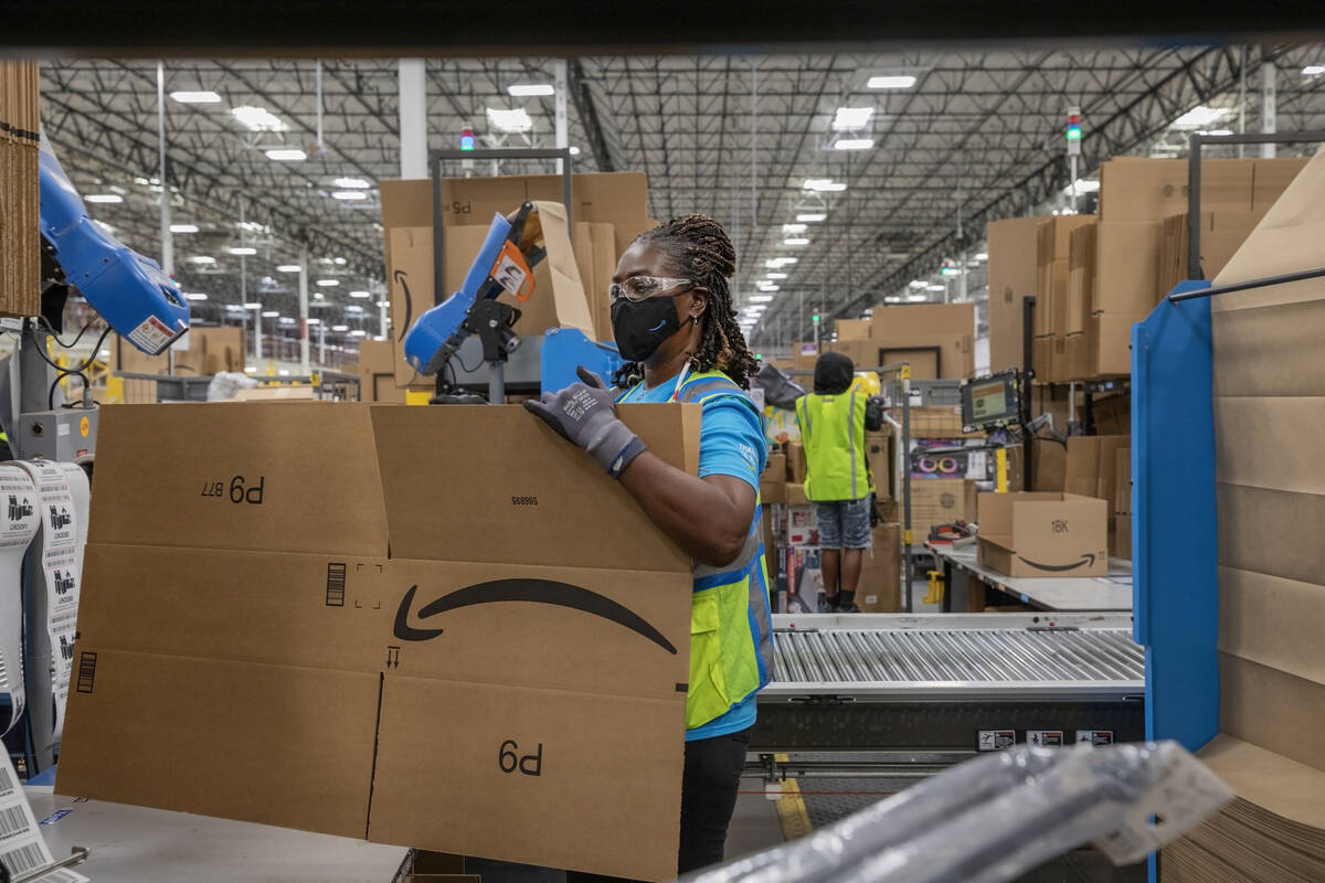 Amazon associate Lola Wickett packages products at an Amazon warehouse in North Las Vegas on Th ...