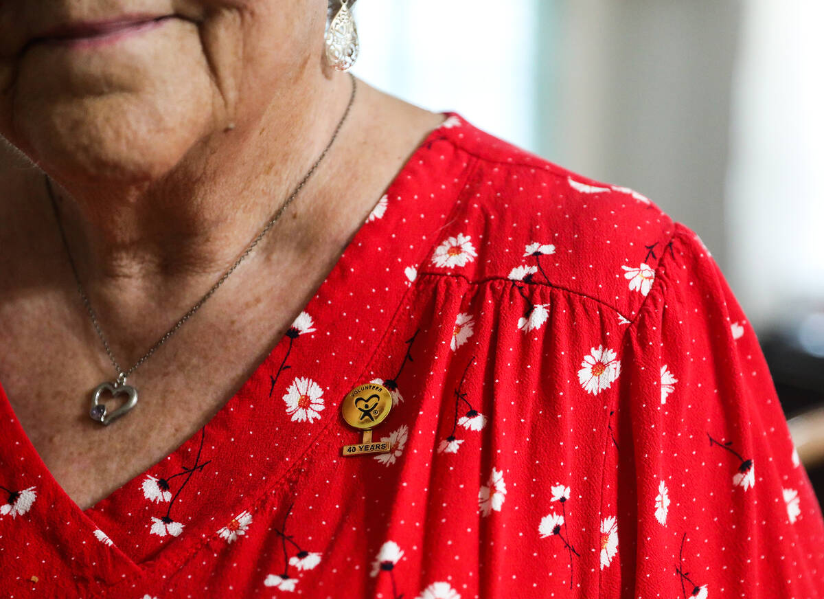 Carolyn Muscari shows a pin, which marks her four decades as a volunteer for the Court Appointe ...