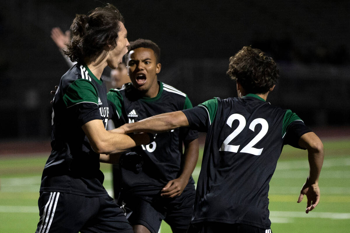 Palo Verde’s Quentin Gomez, left, is congratulated by teammates Philip Bentley, center, ...