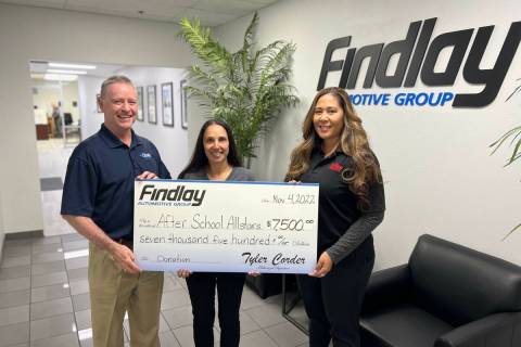 Tyler Corder, left, CFO of Findlay Automotive, and Stephanie Bernas, right, marketing director ...