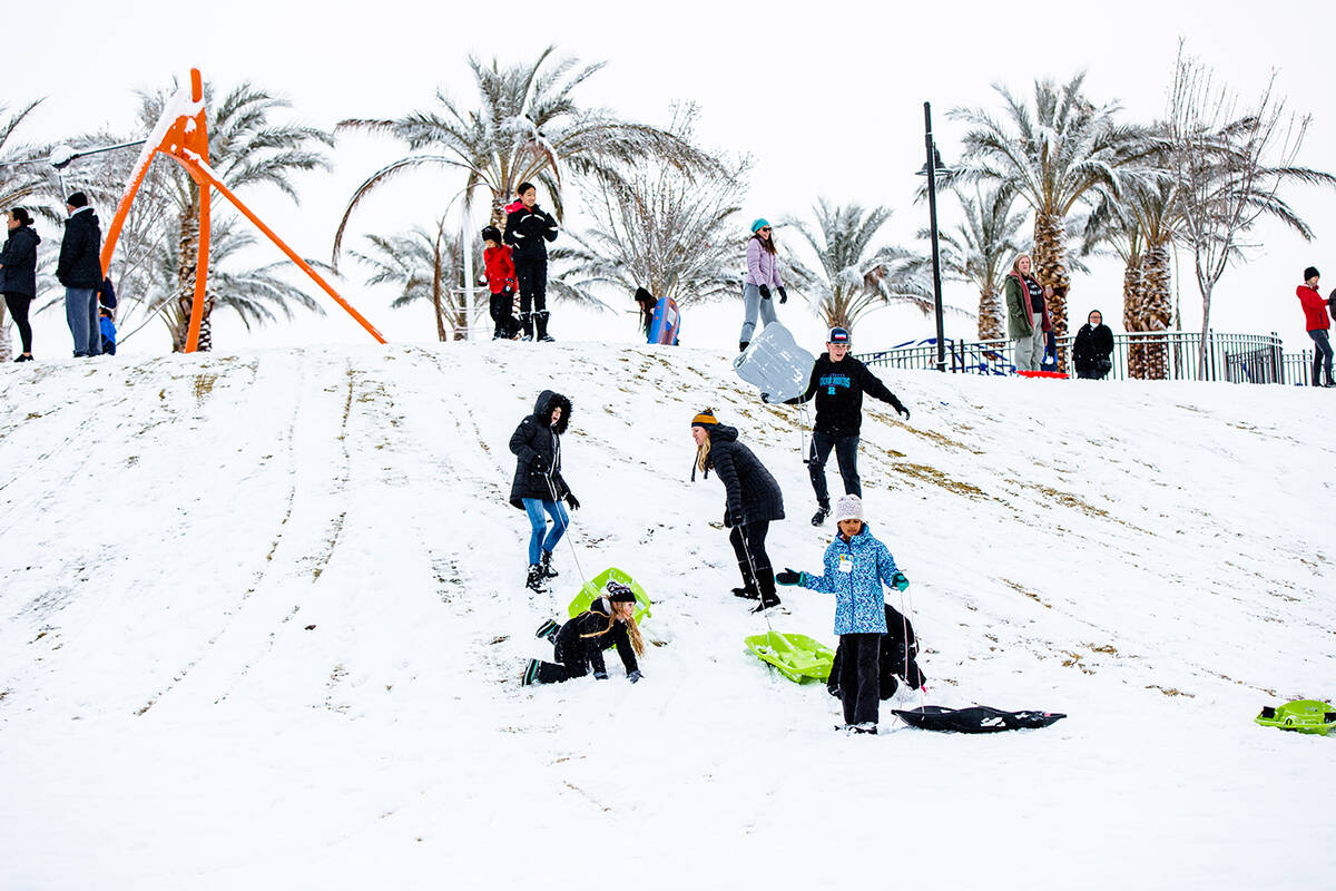 Summerlin residents flocked to Fox Hills Park for wintertime fun during one of the valley’s r ...