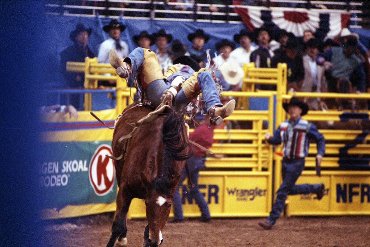 Ken Lensegrav competes in bareback riding in the National Finals Rodeo at the Thomas & Mack Cen ...