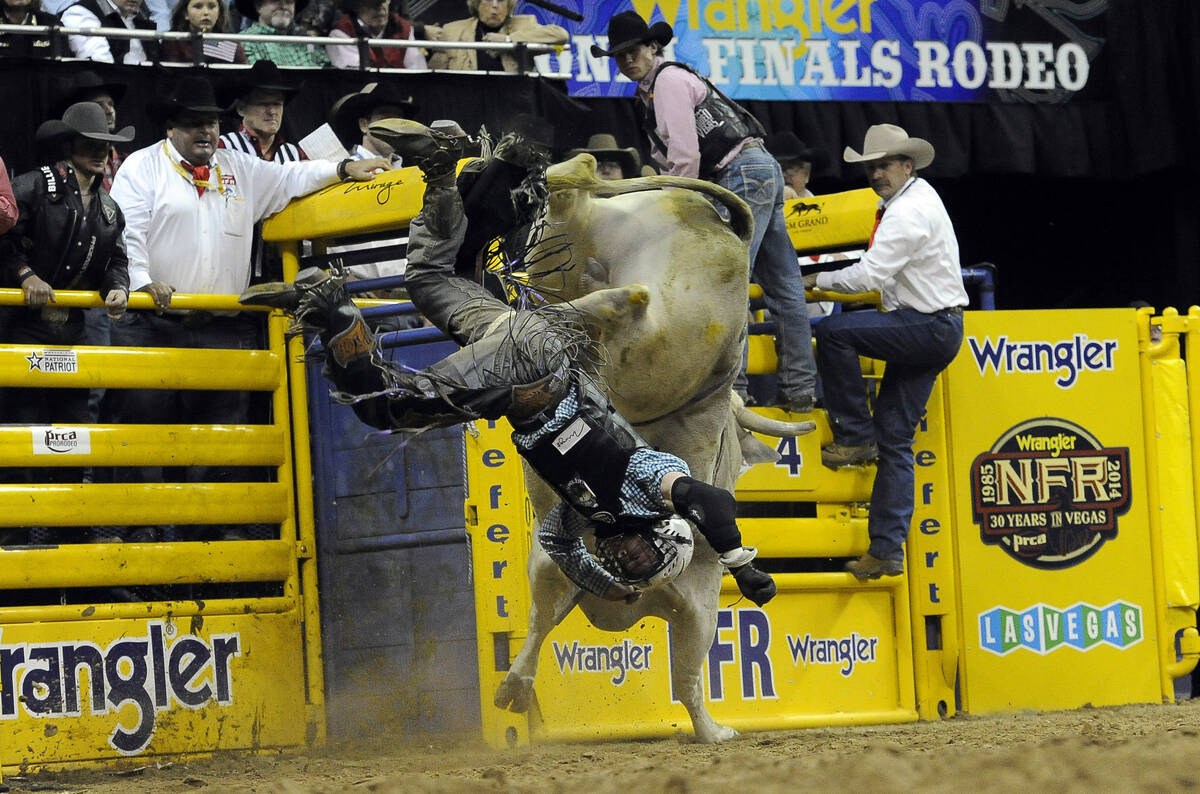 Bull rider Trey Benton III from Rock Island, Texas, is bucked off of Mr. Bull during the tenth ...