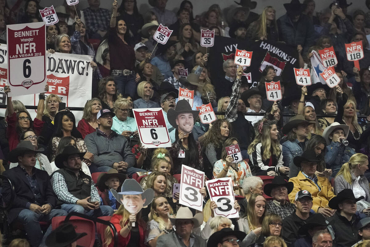 Spectators cheer during the eighth go-round of the National Finals Rodeo at the Thomas & Ma ...