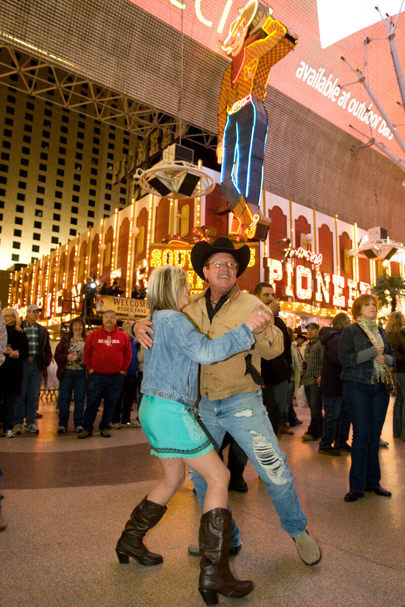 Delbert Ellis of Guthrie, Texas, dances with his daughter-in-law Brittany Ellis of Vernon, Texa ...