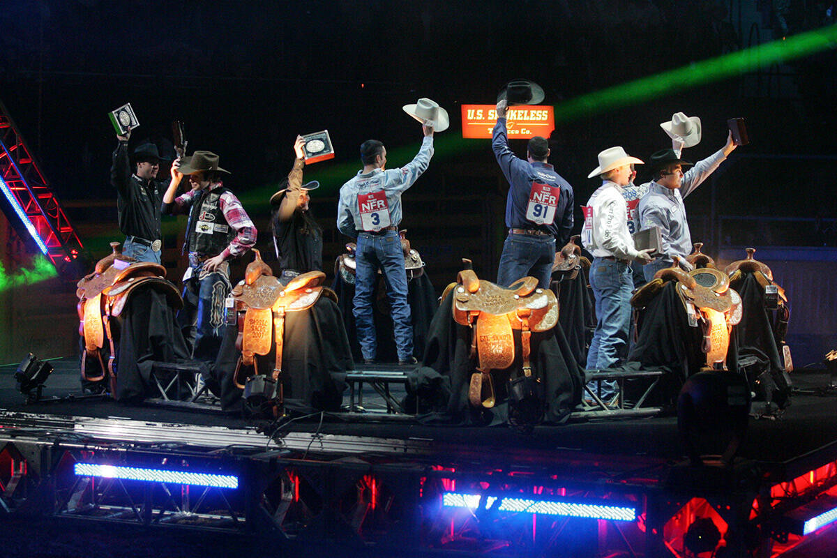 The world champions of all events in the 49th Annual Wrangler National Finals Rodeo wave to the ...