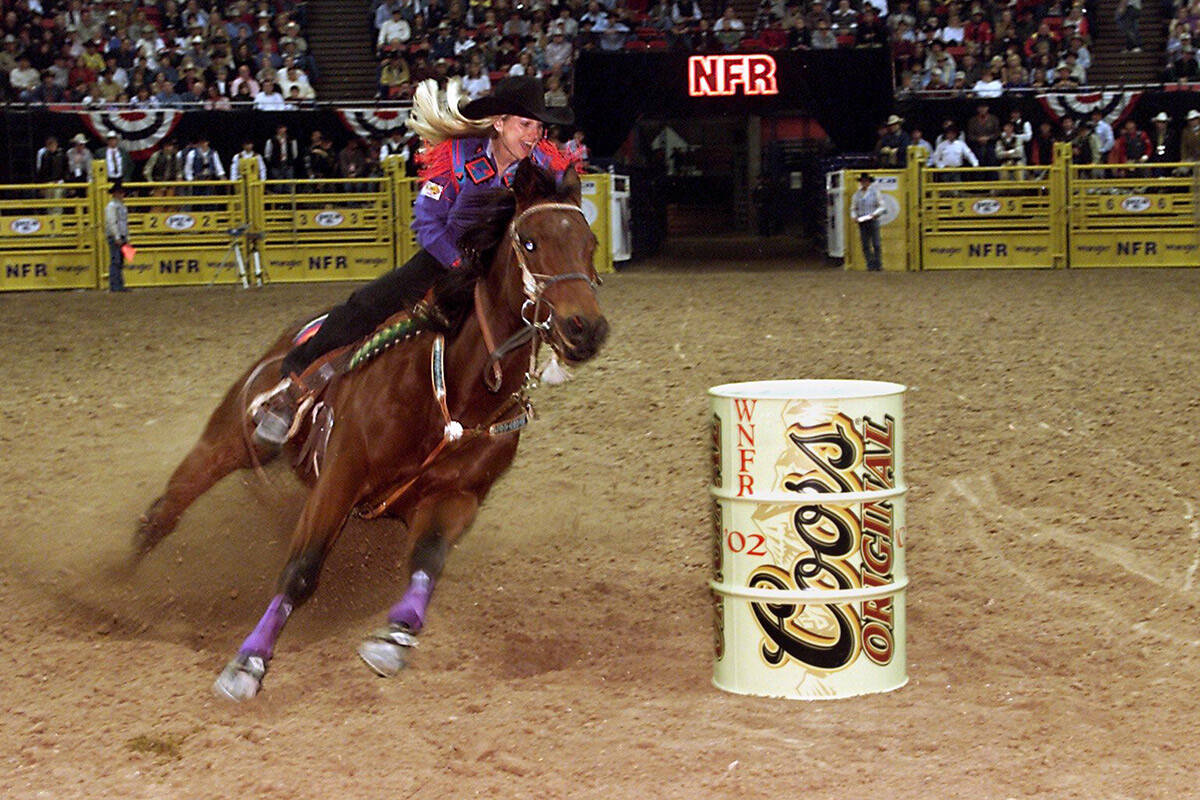 Tammy Key, of Ledbetter, Tex., on her horse, Roundpen, rounds the third barrel during her 13.63 ...