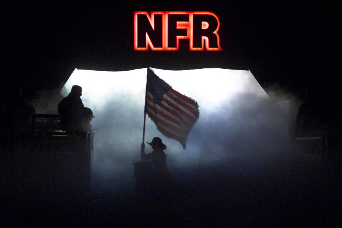 Seven-year-old Orin Honeycutt rides out with the United States flag during a patriotic opening ...