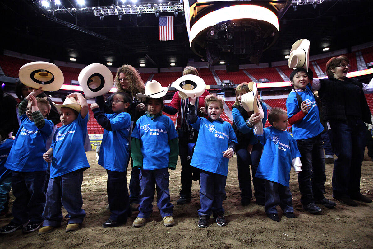 Kids raise their hats before getting started at the Exceptional Rodeo at the Thomas & Mack Cent ...