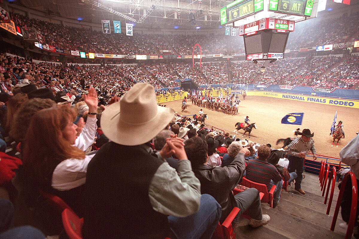 National Finals Rodeo attendees applaud the state flags at the start of the event on Dec. 6, 19 ...