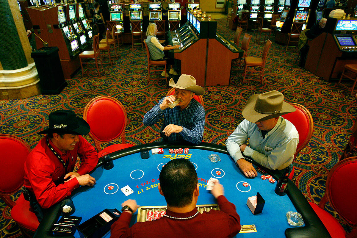 Gussied up in cowboy attire, blackjack players, from left, Jose Calderon, J.D Rule and Brian Ha ...