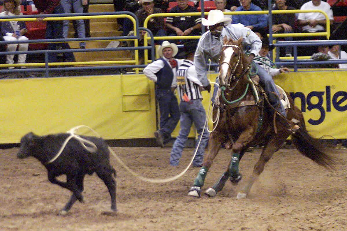 Fred Whitfield of Hockley, Texas, competes in calf roping at the National Finals Rodeo at the T ...