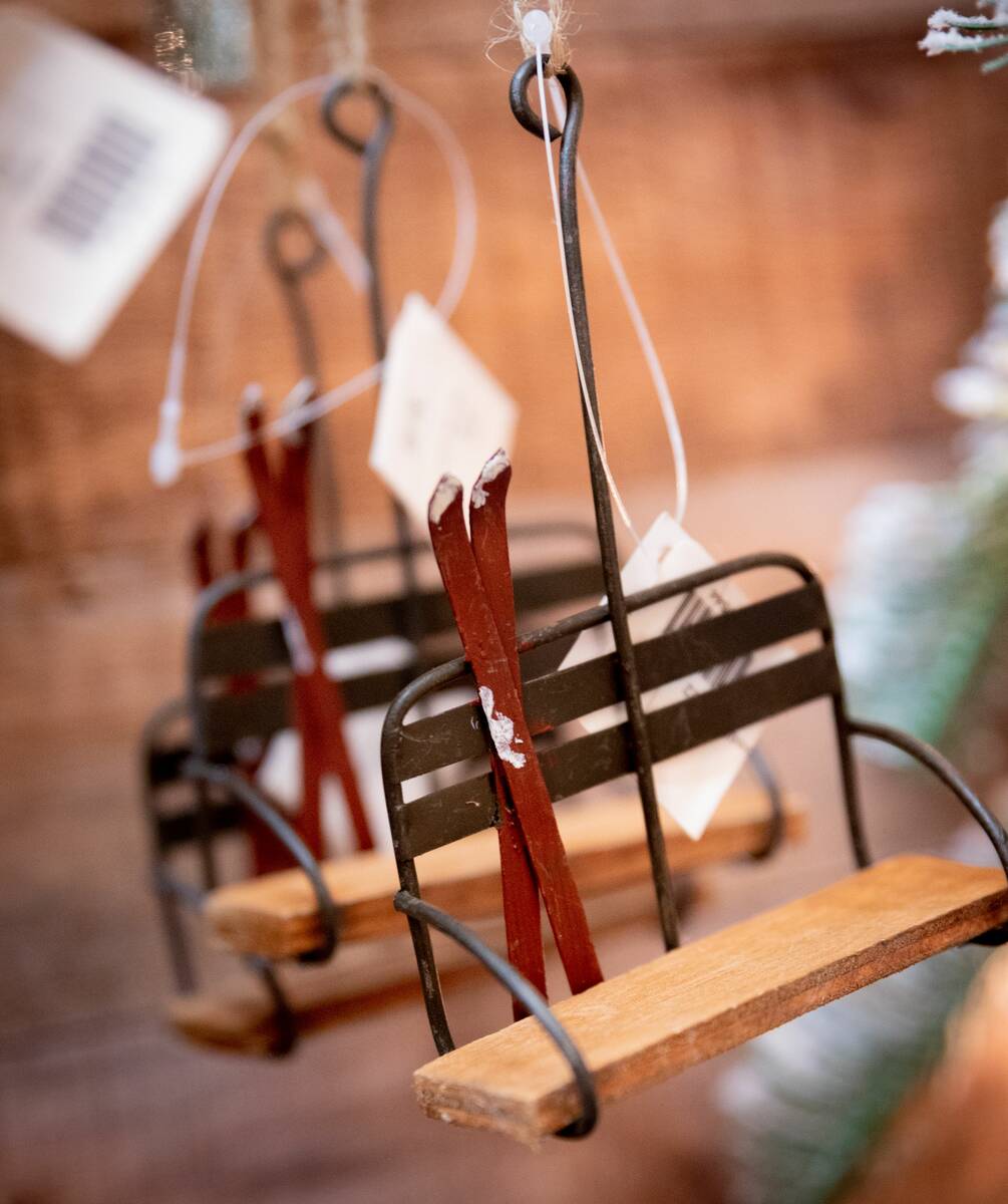 A rustic lodge theme includes pieces such as vintage skis, ice skates, snowshoes, rustic bells, ...