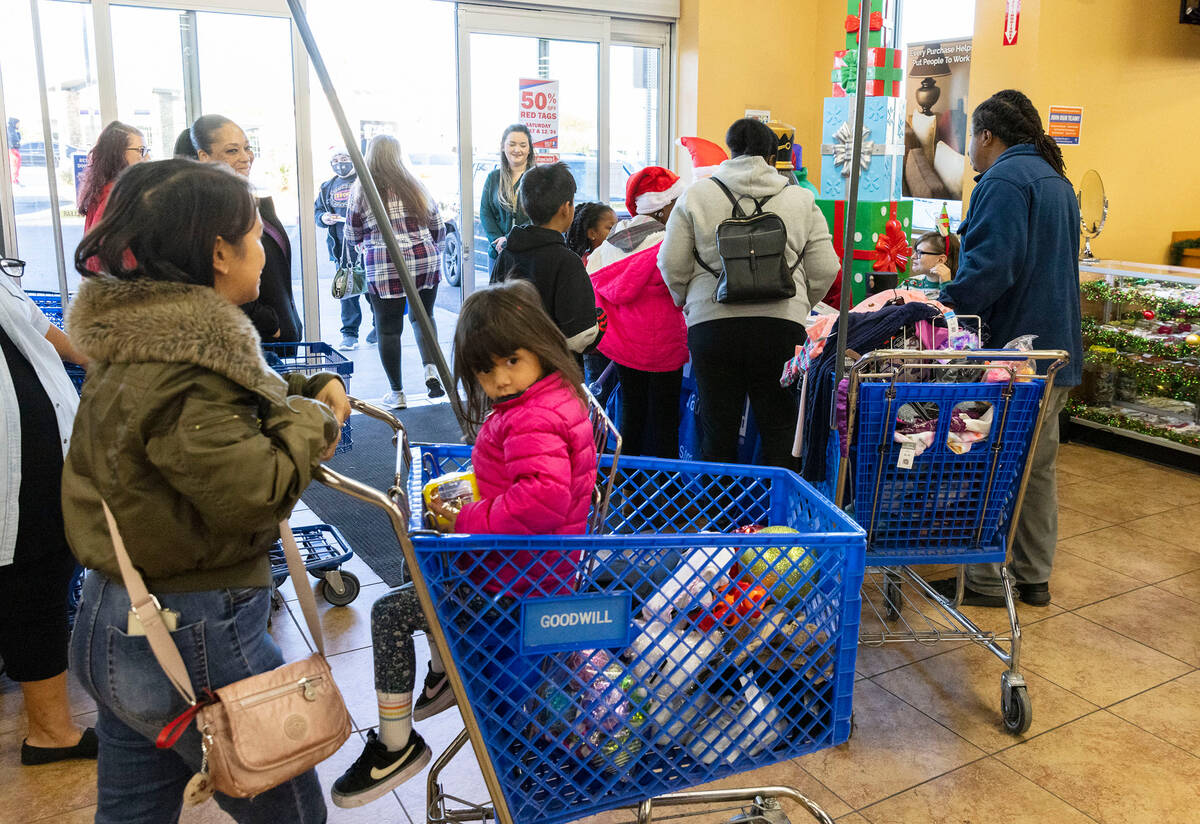 Children and their parents leave after shopping at Goodwill Thrift Store, on Friday, Dec. 2, 20 ...