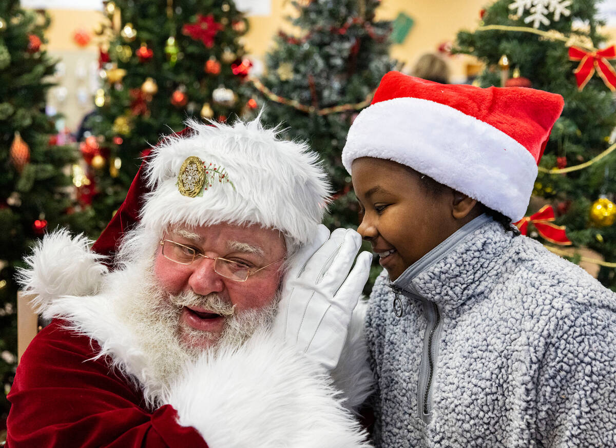 Alexus West, 10, tells her wishes to Santa Claus at Goodwill Thrift Store, on Friday, Dec. 2, 2 ...